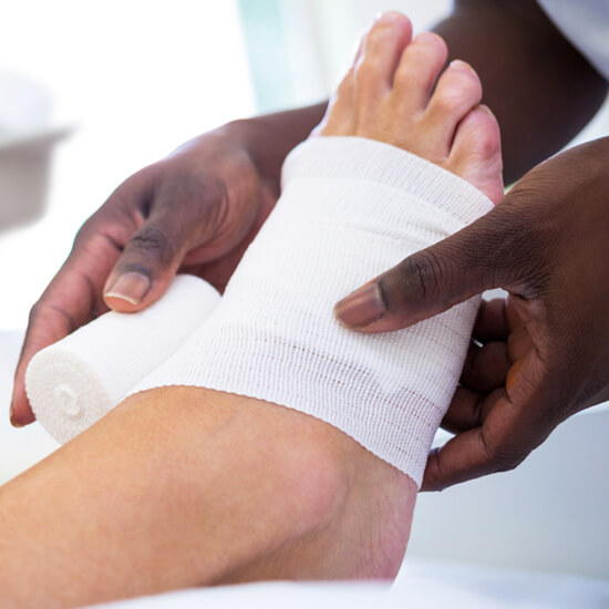 doctor wrapping a patient's foot to treat a wound - MVS Wound Care & Hyperbarics